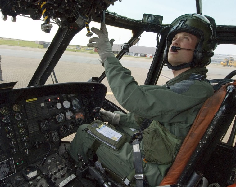 Image: Britain's Prince William is seen sitting at the controls of his Sea King helicopter in this handout photograph received in London